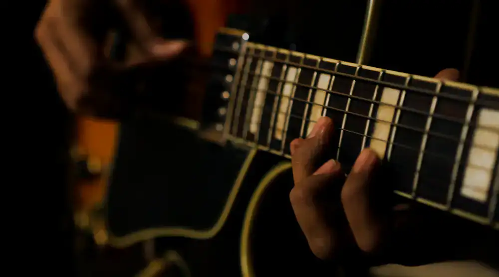 Musicians playing electric guitar in studio