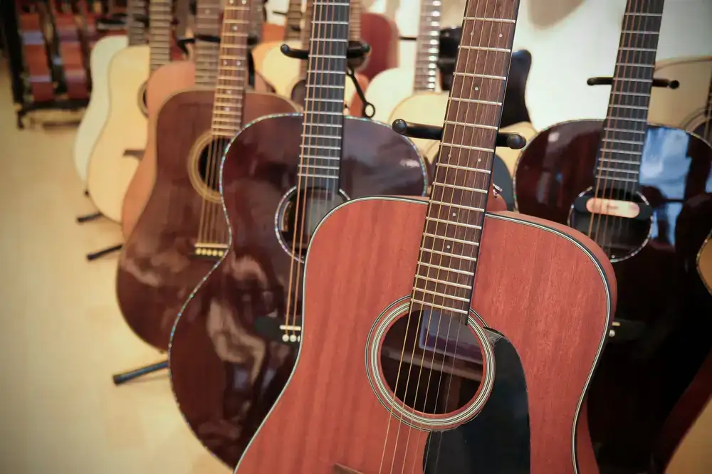 Customer inspecting an acoustic guitar in the Zafnorix showroom